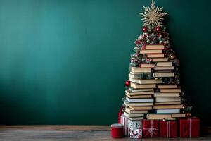 Stack of books arranged like a Christmas tree, topped with a star and ornaments photo