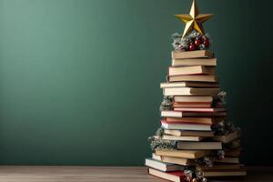 Stack of books arranged like a Christmas tree, topped with a star and ornaments photo