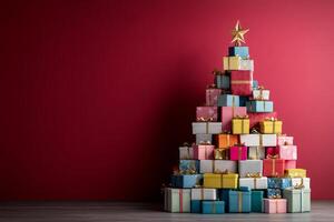 Stack of Christmas presents wrapped in patterned paper on red background photo