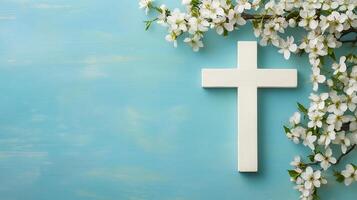 Serene cross adorned with flowers on a tranquil blue background inviting reflection and peace photo