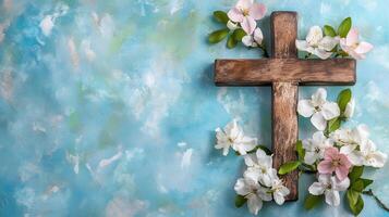 Cross adorned with flowers on a serene blue background in a peaceful setting photo
