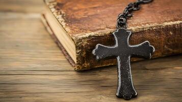 A close-up of a cross resting on an old book background with copy space photo
