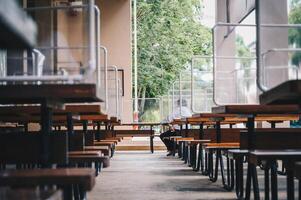 Group of plastic partition setting on table in canteen for reduce and protection the COVID-19 virus spreads in pandemic. Social distancing concept. photo