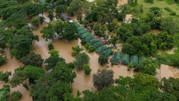 Aerial view of local house in suburb area of Chiang Rai province flooding by Kok river after typhoon Yagi has swept Southeast Asia. photo