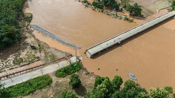 Aerial view of a broken bridge in Doi Hang subdistrict after Typhoon Yagi has swept Chiang Rai province of Thailand. photo
