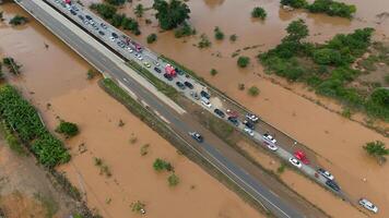 Aerial view of car stuck on the bridge after road flooded during typhoon Yagi has swept Chiang Rai province of Thailand. photo