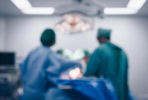 Blurred image background of medical team performing surgical operation in operating room. An operating room may be designed and equipped to provide care to patients. photo