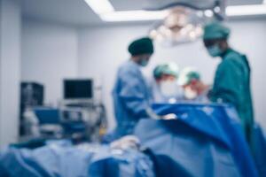 Blurred image background of medical team performing surgical operation in operating room. An operating room may be designed and equipped to provide care to patients. photo