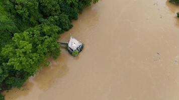 Aerial view of white Buddha statue situated on the rock while Mae Kok river rising during typhoon Yagi has swept Southeast Asia. photo