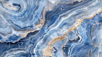 Elegant blue and gold marble texture with flowing patterns and rich variations in depth photo
