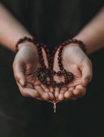 A person praying with a rosary during a moment of reflection and devotion photo