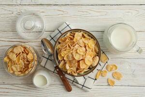 Concept of breakfast with muesli and milk on white wooden table photo