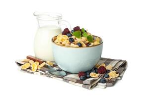 Napkin with milk, muesli and spoon isolated on white background photo