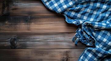 Blue and white checkered plaid on wooden background, top view with space for text photo