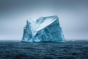 Giant iceberg floating in the ocean under a cloudy sky photo