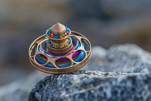 Modern artistic spinning top balancing on a rock photo