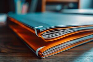 Stack of folders sitting on desk in office representing paperwork photo