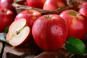 Red apple with water droplets resting on rustic wooden surface photo