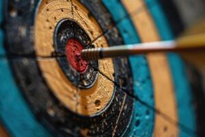 Arrow hitting the center of an archery target photo