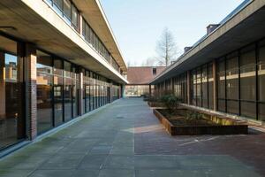 Empty courtyard of modern university building with glass facade photo