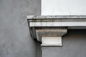 Detail of a building facade showing signs of weathering and age photo