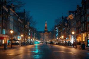 Tourists walking down empty street with lit lanterns at night in amsterdam, netherlands photo