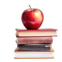 Red apple resting on stack of books symbolizing knowledge photo