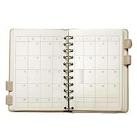 Open notebook showing blank calendar pages for important dates photo