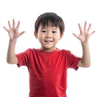 Smiling asian boy showing ten fingers up on white background photo