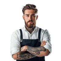Serious bearded tattooed man with arms crossed wearing apron photo