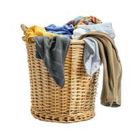 Wicker laundry basket overflowing with clothes on white background photo