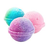 Three colorful round bath bombs creating gradient on white background photo