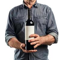 Winemaker holding a bottle of red wine with blank label photo