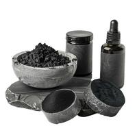 Activated charcoal powder, scrub, cream and serum standing on stone pedestal photo