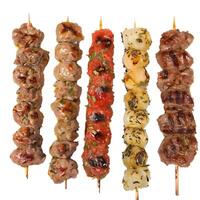 Five skewers with grilled meat, tomatoes and onions isolated on white background photo