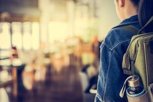 A woman with a backpack and a water bottle photo