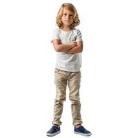 Serious young boy standing with folded arms on white background photo