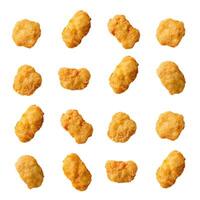 Delicious crispy chicken nuggets floating on white background photo