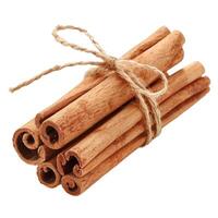 Cinnamon sticks tied with natural twine string isolated on white photo