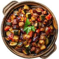 Rustic clay pot overflowing with roasted vegetables and herbs photo