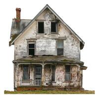 Old desolate house falling apart with boarded up windows photo