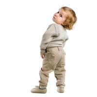 Cute toddler boy turning around on white background photo