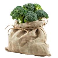 Freshly harvested broccoli heads overflowing from burlap sack photo