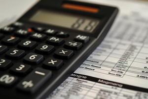 Accountant using calculator calculating invoice tax return photo