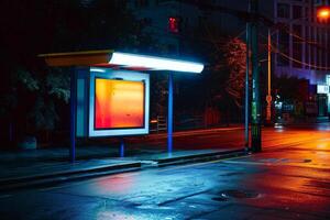 Empty bus stop illuminated at night with orange and blue lights photo