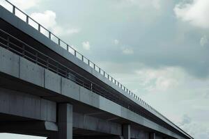Concrete elevated highway is stretching into the distance under cloudy sky photo
