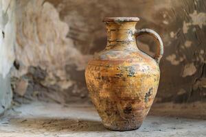 Old clay pitcher standing on a dusty surface in an abandoned house photo