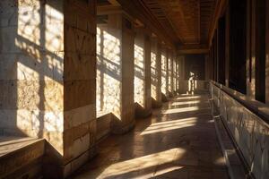 Sunlight casting long shadows through windows in ancient building photo