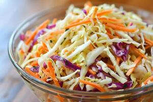 Freshly made coleslaw salad is served in a glass bowl photo