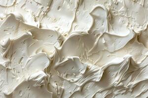 Closeup view of a smooth and undulating creamy texture with shadows photo